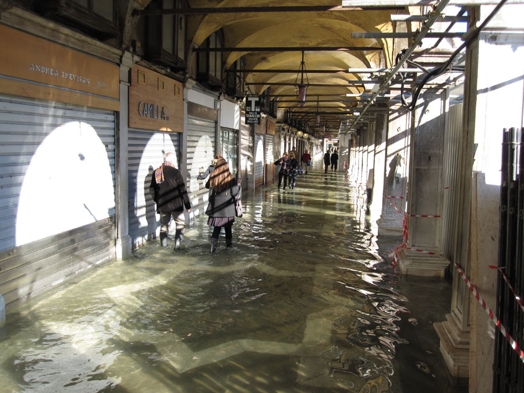 people walking on a flooded corridor