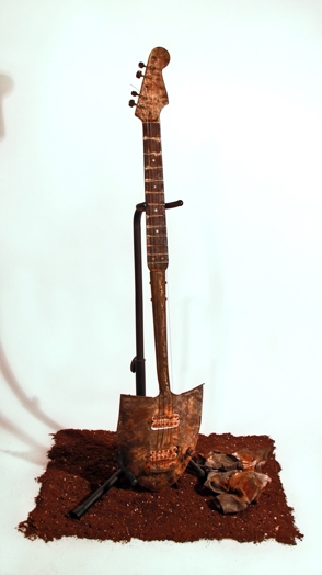 small electric guitar made of a shovel