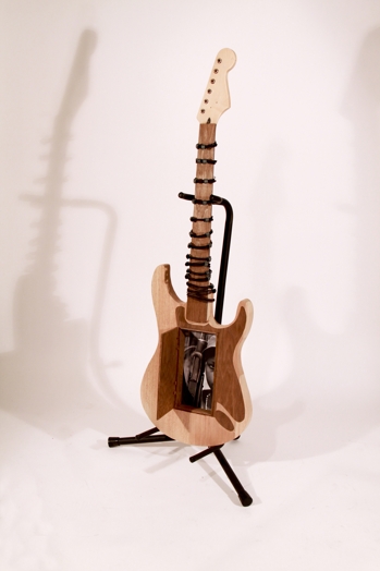 small electric guitar made of wood