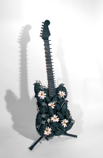 a small green electric guitar with small flowers on it