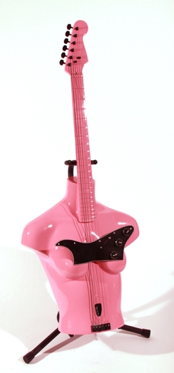 a pink electric guitar with the body in the shape of a woman's mannequin bust