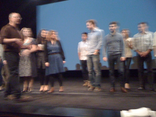blurry image of people being on a stage