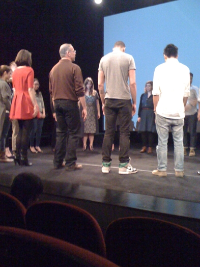 a human circle formed by people on the stage of the ideopolis event presentation