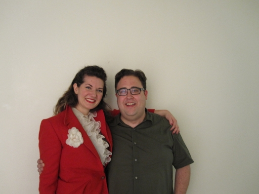 portrait of a woman in red jacket and a man in a short sleeve shirt