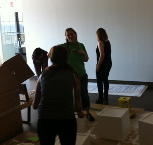 four people working on the preparation and installation of the Ideopolis exhibition