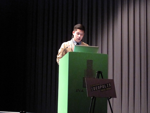 a young student giving a speech on a green stand