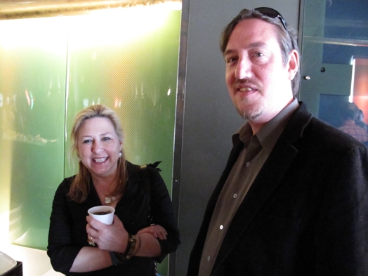 photo of a man and a woman with a coffee cup in her hand