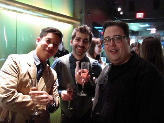 photo of  three men having, each having a glass of champaign