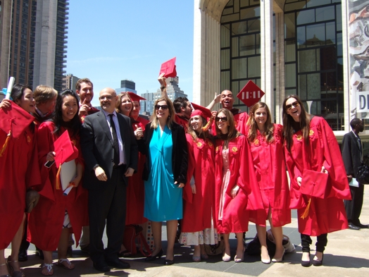 students in red ropes at graduation with two professors