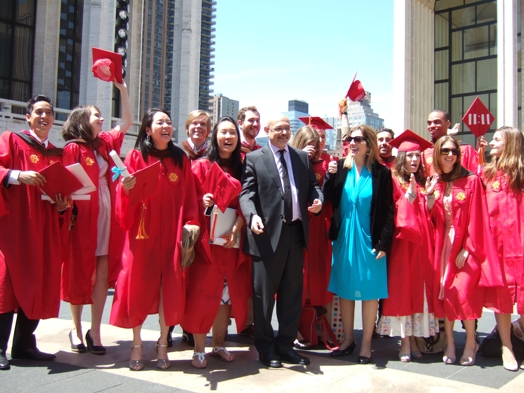 students in red ropes at graduation with two professors