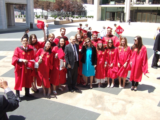 group photo of students in red cloths at the graduation