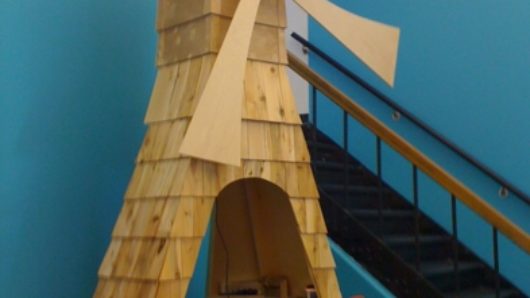 a wood-made windmill with support for mini golf crosses