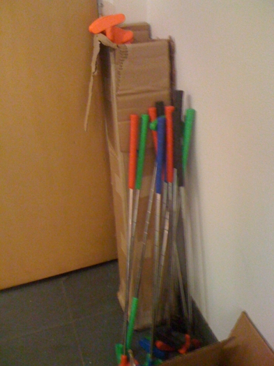golf crosses put in a corner near a box