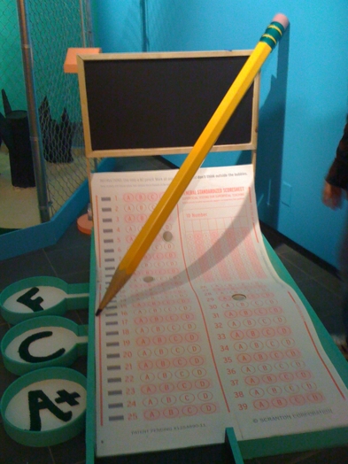 mini-golf course with the course looking like a lottery ticker and a pencil over it