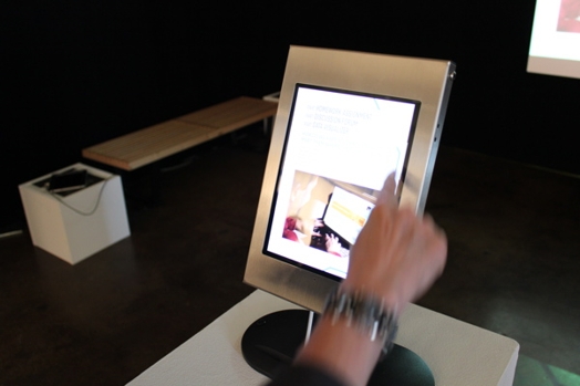 a hand is touching an iPad's screen to scroll the content