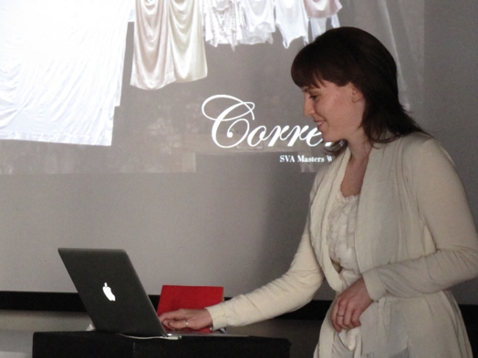woman in white dress giving powerpoint presentation