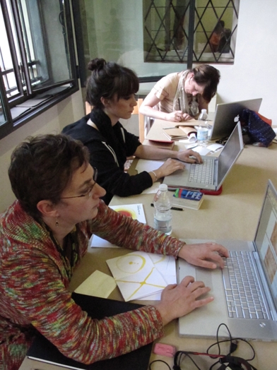 three women working on a laptop