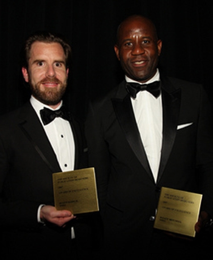 portrait of two men in black suits and white shirts