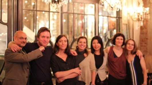 group photo of seven people in a restaurant