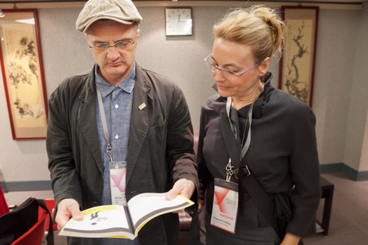 portrait of two people having a look at a book