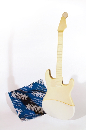 small guitar figurine with a condom