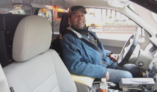 a portrait of a taxi driver in the driver's seat