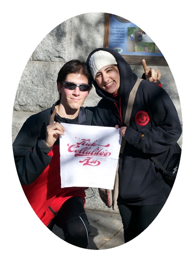 a portrait with two persons holding a piece of fabric with the red typography kick cellulite's ass