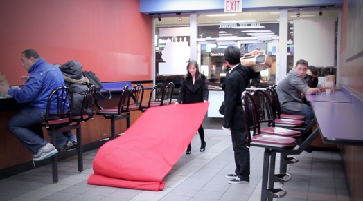 a woman is arranging a red carpet in a restaurant