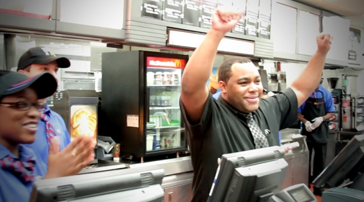 image of a man with his hands up in the  air in a restaurant