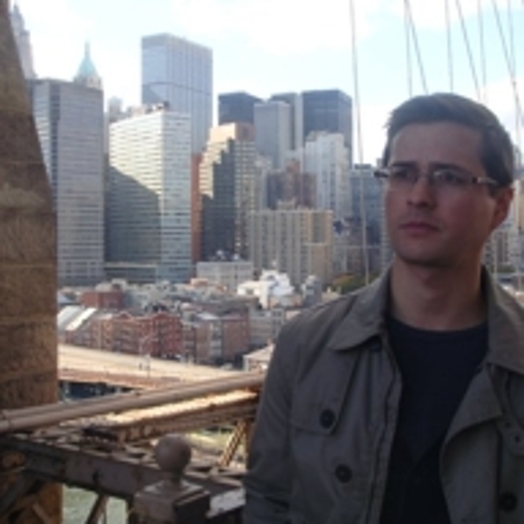 portrait of a man with city buildings in the background