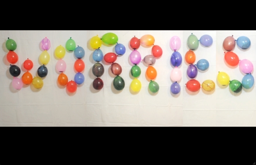 worries word composed of colored balloons mounted on a wall