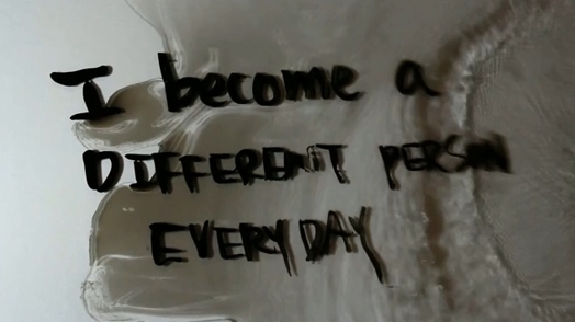 "i become a different person everyday" written with a marker on a reflective surface