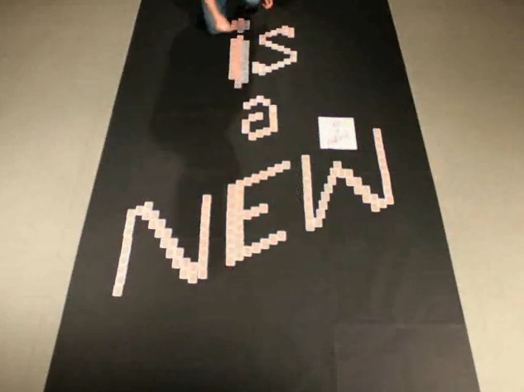 a man working on a large scale banner