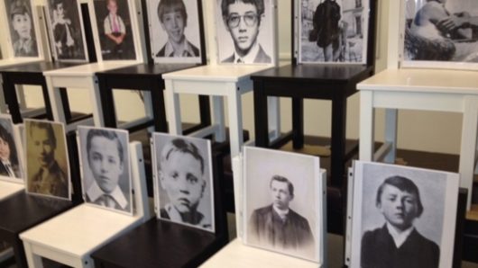 two rows of chairs with portraits on them