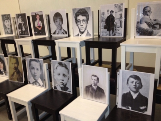 two rows of chairs with portraits on them