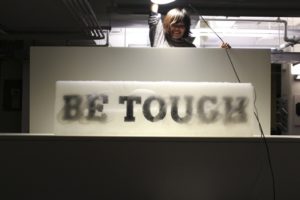 be touch banner and a person orienting a light above it