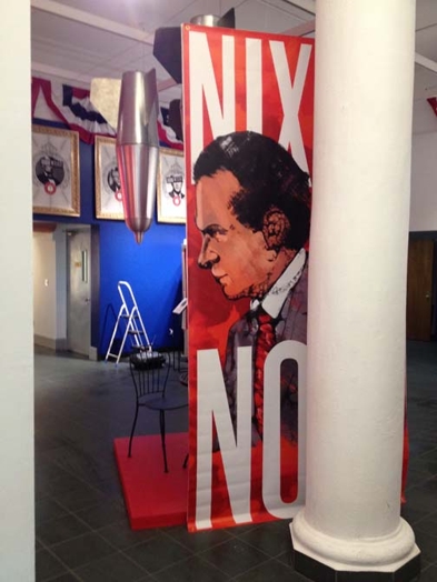vertical banner with a profile illustration graphic with Nixon near a white staple