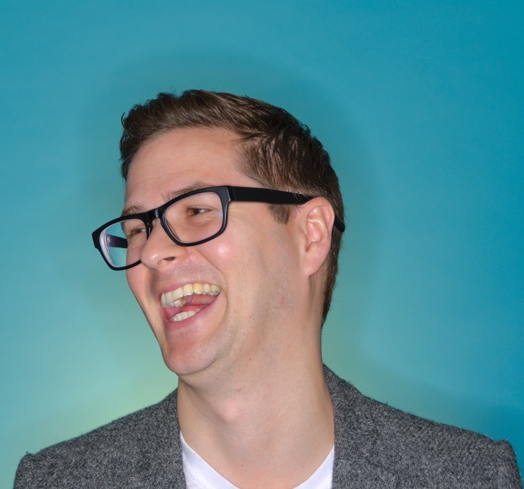 portrait of a man with glasses laughing