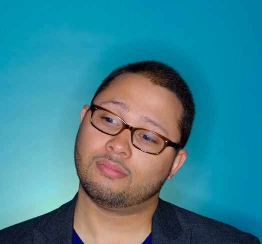 portrait of a man with short hair and glasses