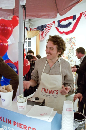 man with mustache serving food with apron