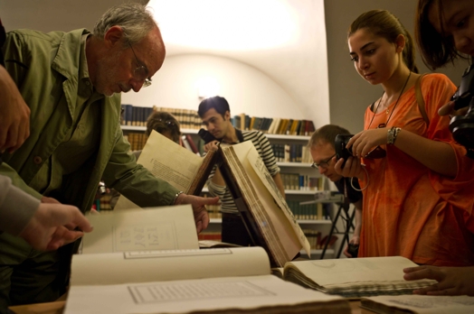 students looking at old books