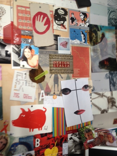 inspiration board with poster and paper pinned on wall