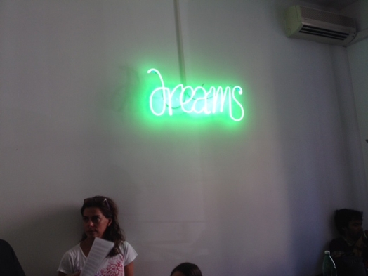 room with woman, an air conditioner and a word with neon light typography