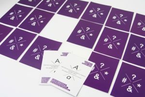 surprise cards with a purple back and two are turned over to reveal a white side and A letter with some text below it