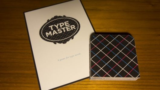 A photo of the Type Master rule book game and some tiles.
