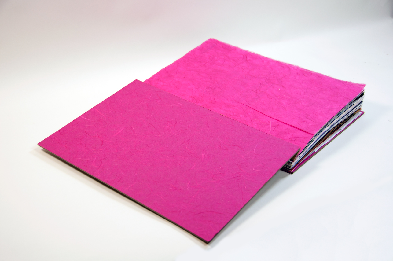 an opened book with the pre-cover in pink pages