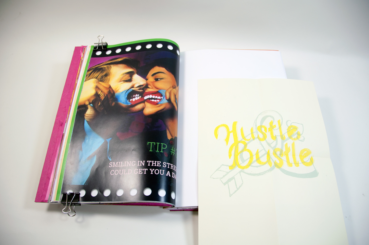 an opened book with an image of two people on the left side and a piece of paper with a yellow typography Hustle Bustle on the right side