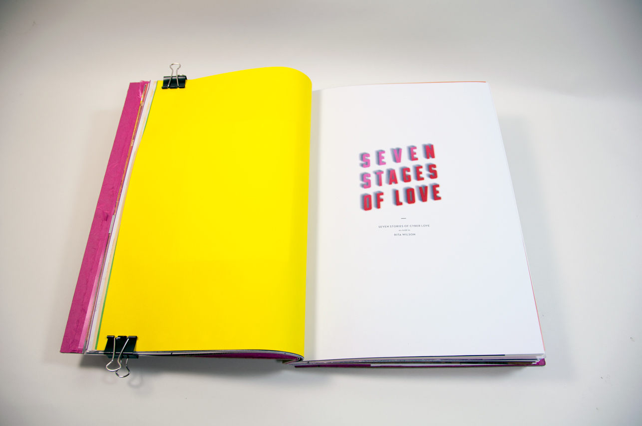 an opened book with a page having a typography text: seven stages of love