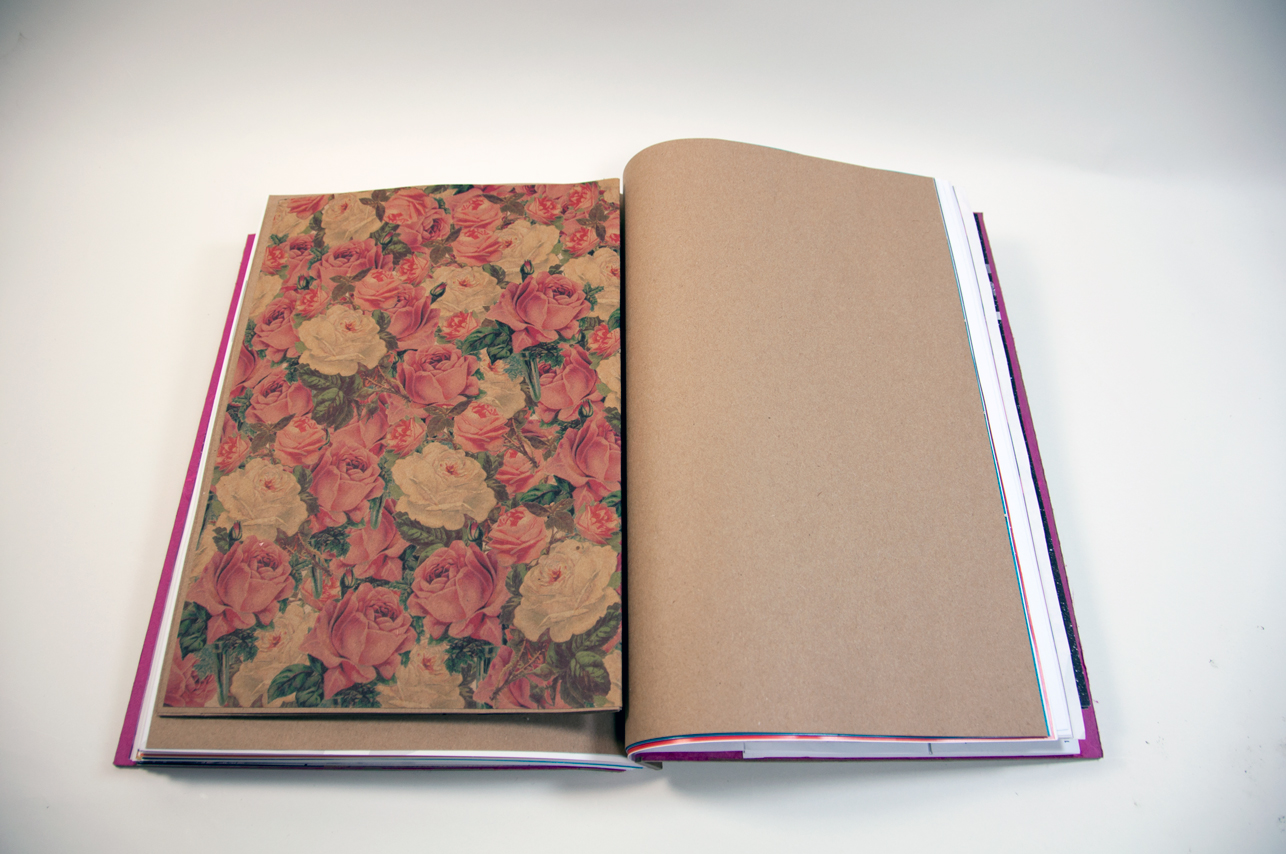 an opened book with a picture of flowers on the left, and an empty brown page on the right