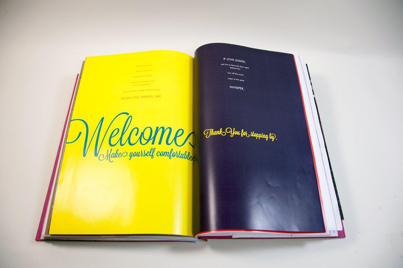 an opened book with the yellow page and green welcome word on the left, and a blue page with some yellow text on the right